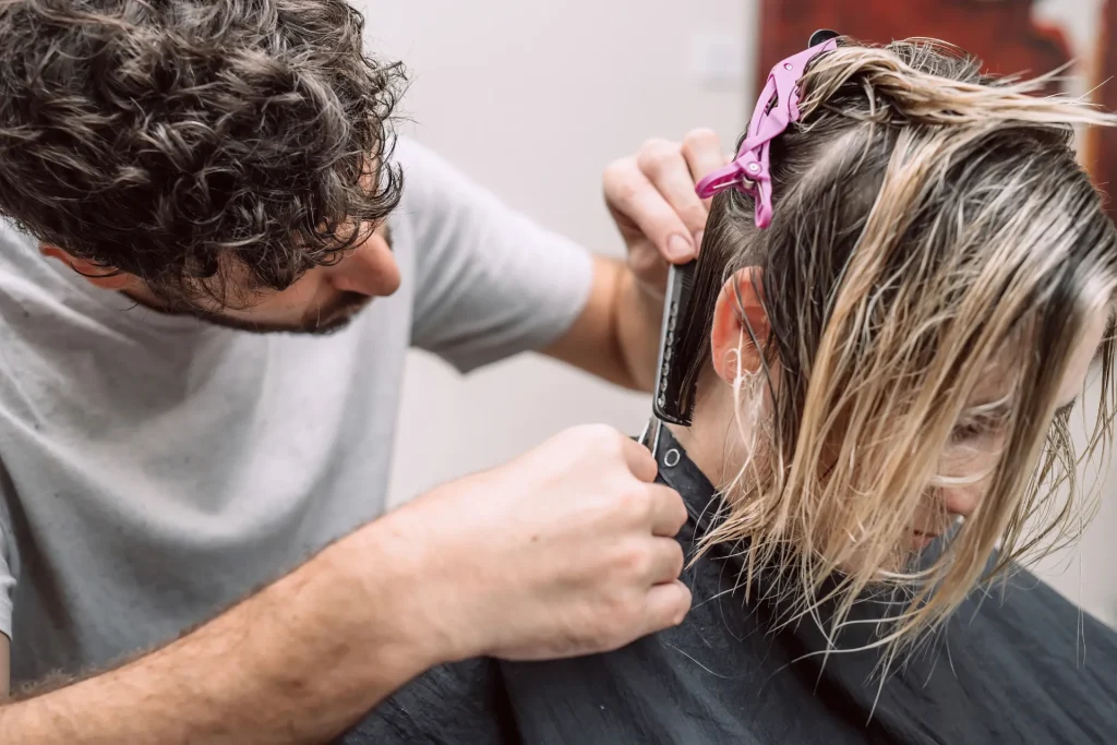master hairdresser cuts hair of blond woman in sal 2026 03 17 17 11 46 utc